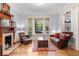 Cozy living room with a stone fireplace, hardwood floors, and ample natural light at 848 S Emerson St, Denver, CO 80209
