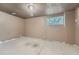 The basement has concrete flooring and one window to allow natural light at 16623 E Asbury Pl, Aurora, CO 80013