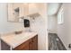 Cozy bathroom featuring a vanity with sink, modern fixtures, and tiled floors at 16623 E Asbury Pl, Aurora, CO 80013