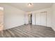 Spacious bedroom with wood-style floors, closet space, and access to the ensuite bathroom at 16623 E Asbury Pl, Aurora, CO 80013
