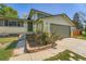 Exterior view of a home with neutral siding, a front garden, and an attached garage at 16623 E Asbury Pl, Aurora, CO 80013