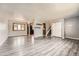 Open living space featuring wood-look floors, neutral walls, and an open layout at 16623 E Asbury Pl, Aurora, CO 80013