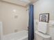 Bright bathroom featuring a bathtub with blue curtain and retro van decor at 1020 15Th St # 24H, Denver, CO 80202