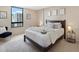 Cozy bedroom with a large window offering city views, complemented by a plush bed and stylish decor at 1020 15Th St # 24H, Denver, CO 80202
