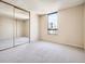 Bright bedroom with a mirrored closet, carpeted floor and large windows with city views; modern living at 1020 15Th St # 24H, Denver, CO 80202