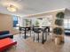 Bright common room with high-top tables, chairs, and large windows with city views at 1020 15Th St # 24H, Denver, CO 80202