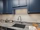 Close-up of a kitchen featuring marble countertops, stainless steel faucet and modern appliances, well designed at 1020 15Th St # 24H, Denver, CO 80202