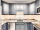 Stylish kitchen featuring custom cabinets and marble countertops, offering both functionality and aesthetic appeal at 1020 15Th St # 24H, Denver, CO 80202