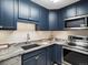 Well-appointed kitchen with stainless steel appliances, including a microwave, stove, and sleek marble countertops at 1020 15Th St # 24H, Denver, CO 80202