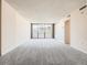 Large open living space with balcony access, featuring neutral carpet and bright walls at 1020 15Th St # 24H, Denver, CO 80202