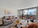 Cozy living room with balcony access and stunning cityscape views at 1020 15Th St # 24H, Denver, CO 80202