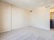 Neutral-toned living room featuring neutral walls, carpet flooring and a doorway leading to a bathroom with a granite vanity at 1020 15Th St # 24H, Denver, CO 80202