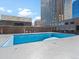 Empty outdoor pool with surrounding buildings and blue sky in the background at 1020 15Th St # 24H, Denver, CO 80202