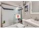 Clean bathroom featuring tub with sliding glass door, white vanity and tile at 1760 S Ammons St # D, Lakewood, CO 80232