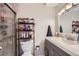 Well-lit bathroom featuring a shower, modern vanity and a neutral color palette at 1760 S Ammons St # D, Lakewood, CO 80232