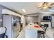 Modern kitchen featuring stainless steel appliances, center island with seating, and white cabinets at 1760 S Ammons St # D, Lakewood, CO 80232