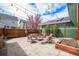 Expansive backyard with stone patio, comfortable seating, and decorative lighting, offering a relaxing outdoor retreat at 8460 E 54Th Dr, Denver, CO 80238