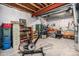 Spacious unfinished basement with exposed ceiling and a variety of storage options and exercise equipment at 8460 E 54Th Dr, Denver, CO 80238