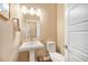 Stylish powder room with a pedestal sink, modern fixtures, and a clean design at 8460 E 54Th Dr, Denver, CO 80238