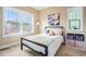 Charming bedroom featuring large windows, colorful artwork, and stylish storage, creating a vibrant space at 8460 E 54Th Dr, Denver, CO 80238