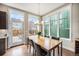 Bright dining room with large windows, a modern chandelier, and seating for six at 8460 E 54Th Dr, Denver, CO 80238