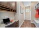 A cozy home office features built-in cabinets, granite desk, and a hallway leading to a convenient mudroom at 8460 E 54Th Dr, Denver, CO 80238
