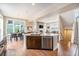 Modern kitchen island and an open-concept layout connecting the kitchen, dining, and living areas at 8460 E 54Th Dr, Denver, CO 80238