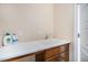 A functional laundry room featuring a sink with a spacious countertop and under-cabinet storage at 8460 E 54Th Dr, Denver, CO 80238