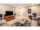 Inviting living room featuring plush seating, a stylish rug, and media center for relaxing and entertaining at 8460 E 54Th Dr, Denver, CO 80238