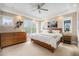 Spacious main bedroom boasts tray ceilings, large windows, and stylish furniture creating a serene retreat at 8460 E 54Th Dr, Denver, CO 80238