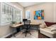 Bright home office with large windows, a modern desk, and comfortable seating at 8460 E 54Th Dr, Denver, CO 80238