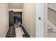A tidy storage area with fitness equipment on a carpeted floor and staircase access at 8460 E 54Th Dr, Denver, CO 80238
