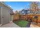 Backyard with privacy fence, artificial turf, and a storage shed, offering a private outdoor space at 1239 S Flower Cir # C, Lakewood, CO 80232
