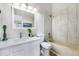 Bright bathroom featuring a modern vanity, stylish mirror, and a tiled shower over a soaking tub at 1239 S Flower Cir # C, Lakewood, CO 80232