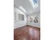 Bedroom featuring hardwood floors, large windows, and a skylight for ample natural light at 1239 S Flower Cir # C, Lakewood, CO 80232