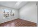 Bedroom featuring hardwood floors, large windows, and a skylight for ample natural light at 1239 S Flower Cir # C, Lakewood, CO 80232