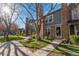 Attractive home exterior with mature trees, brick accents, and green lawn at 1239 S Flower Cir # C, Lakewood, CO 80232