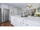 Open concept kitchen featuring stainless steel refrigerator and countertops with barstool seating at 1239 S Flower Cir # C, Lakewood, CO 80232