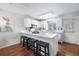 Bright kitchen with white cabinets, countertops, stainless appliances, and barstool seating at 1239 S Flower Cir # C, Lakewood, CO 80232
