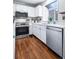 Well-appointed kitchen featuring stainless steel appliances, white countertops and wood flooring at 1239 S Flower Cir # C, Lakewood, CO 80232