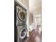 Hallway laundry featuring a stacked washer and dryer, conveniently located near the bedrooms at 1239 S Flower Cir # C, Lakewood, CO 80232