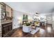 Comfortable living room featuring a stone fireplace and views into the kitchen at 1239 S Flower Cir # C, Lakewood, CO 80232