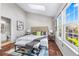 Cozy main bedroom featuring a skylight, large windows, and hardwood flooring at 1239 S Flower Cir # C, Lakewood, CO 80232
