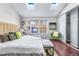 Bright main bedroom featuring a bench, hardwood floors, and windows at 1239 S Flower Cir # C, Lakewood, CO 80232