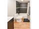 Bathroom with tiled shower and wood-look flooring at 777 N Washington St # 508, Denver, CO 80203