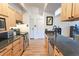 Bright kitchen featuring granite counters, stainless appliances, and wood cabinets at 777 N Washington St # 508, Denver, CO 80203