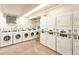 Clean laundry room featuring multiple washers and dryers for convenient use at 777 N Washington St # 508, Denver, CO 80203
