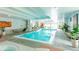 Beautiful indoor pool with lounge chairs, plants and bright lighting at 777 N Washington St # 508, Denver, CO 80203