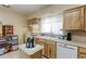 A bright kitchen features wooden cabinets and modern appliances, perfect for preparing delicious meals at 1470 S Eaton St, Lakewood, CO 80232