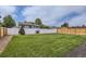 Large, meticulously manicured backyard with privacy fence, grass and gravel area at 450 Lone Pine St, Fort Lupton, CO 80621